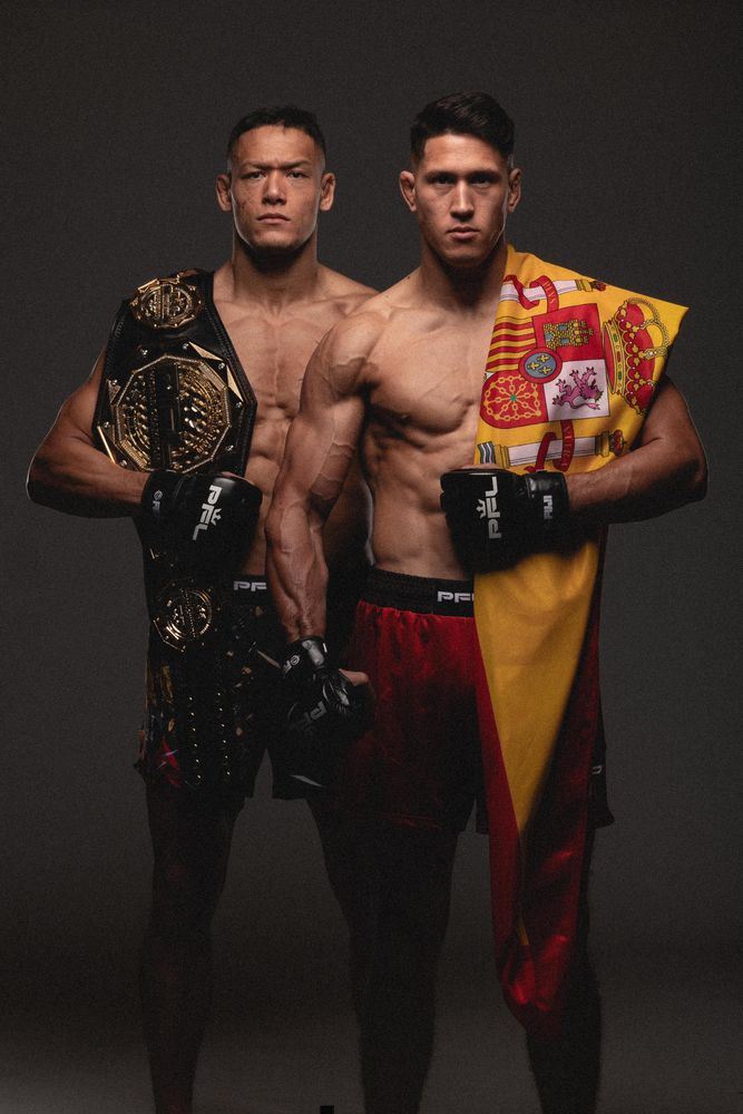 Costello with the belt next to a fighter holding the Spanish flag